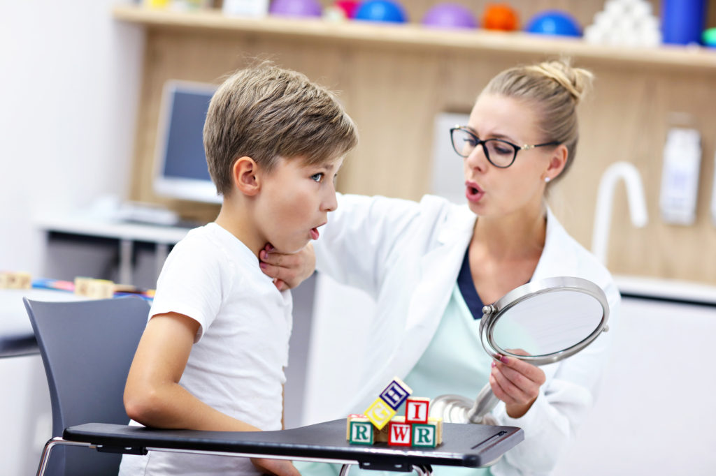 speech-therapist-working-with-young-boy-in-the-classroom